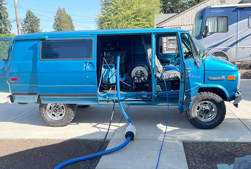 blue van with steam cleaning machine rigged inside to clean carpets