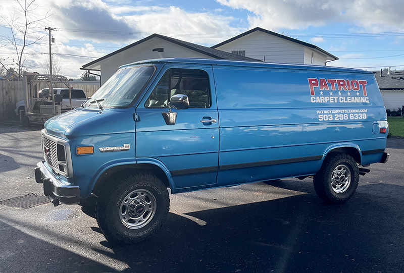 blue van Red text Patriot with 5 white stars and white text Carpet Cleaning